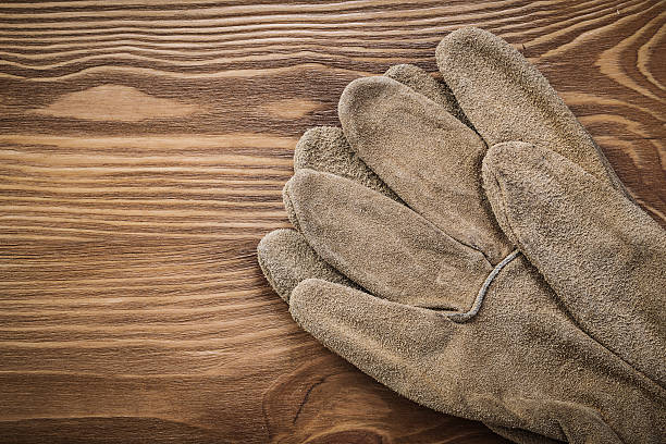 istock Brown protective gloves on vintage wood board construction conce 538326982