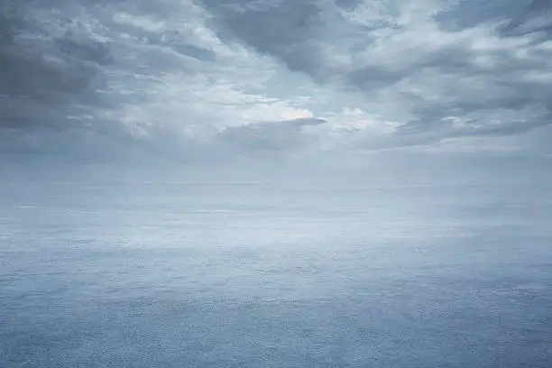 Empty frozen lake and dramatic sky and copy space
