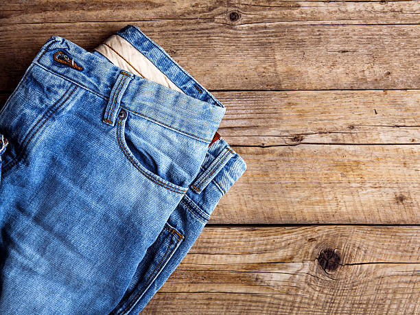 istock Jeans on wooden background. The upper part. 538330046