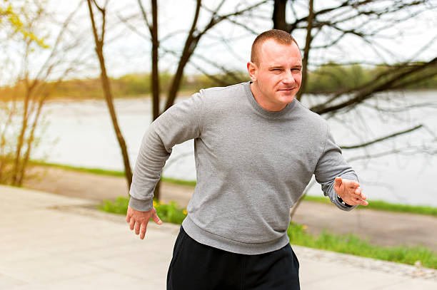 Man run by the river. Outdoor jogger. stock photo