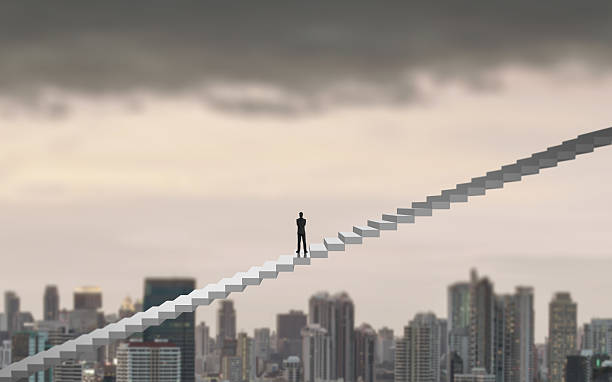 istock Businessman climbing on adder over city looking ahead 538331562