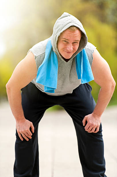 Fit man resting after jogging. stock photo