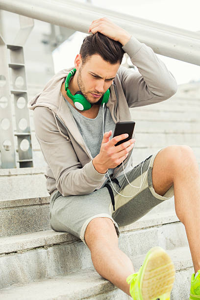 istock Young man outdoors texting and looking worried 538332660