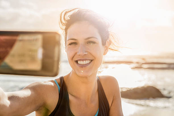 istock Happy young woman taking selfie at beach 538334024
