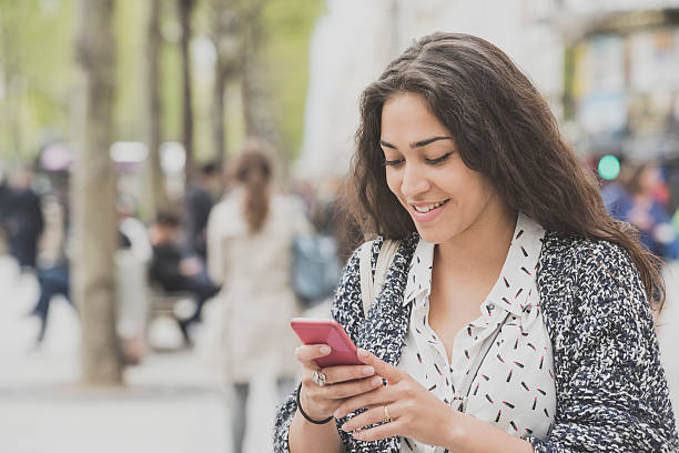 istock Young woman texting on phone, smiling 538334884