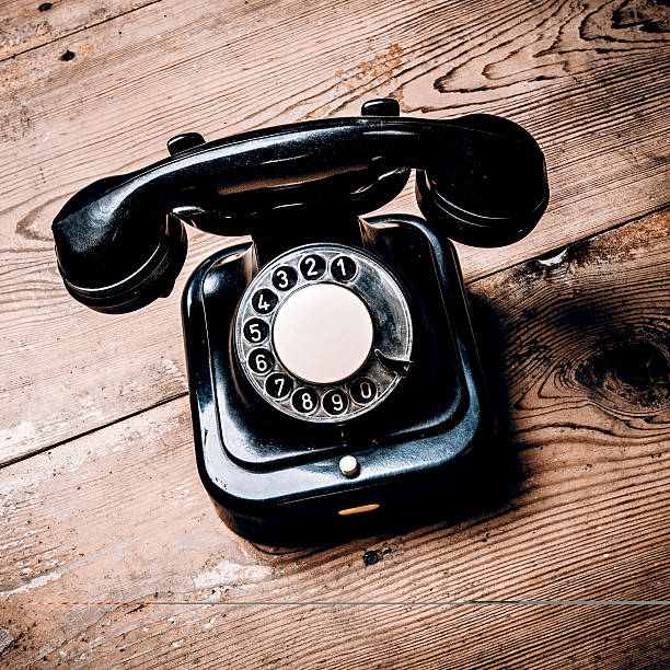 istock Old black phone with dust and scratches on wooden floor 538335530