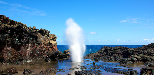 Nakalele Blowhole in Maui Hawaii, produces powerful geyser-like water spouts with the waves and tides. Water spewed from the blowhole can rise as high as 100 feet in the air