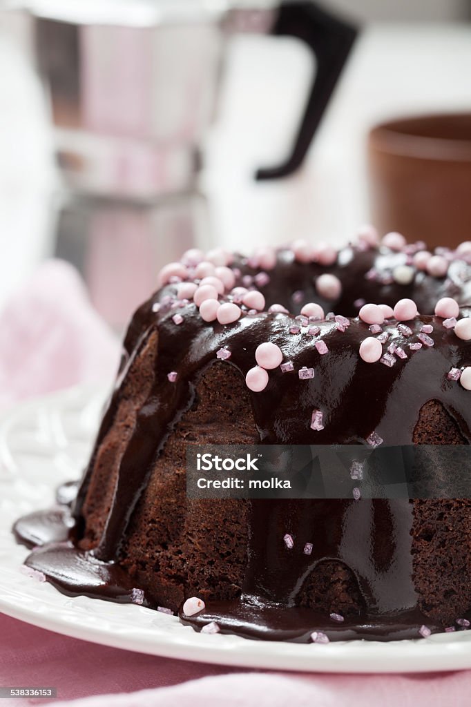 Chocolate bundt cake Chocolate bundt cake with pink decorations 2015 Stock Photo