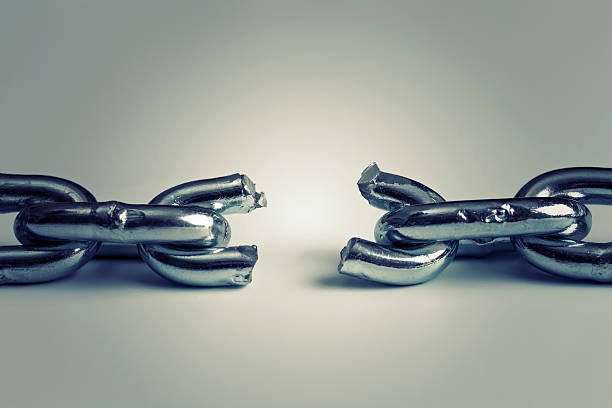 conflict in business concept with broken chain stock photo
