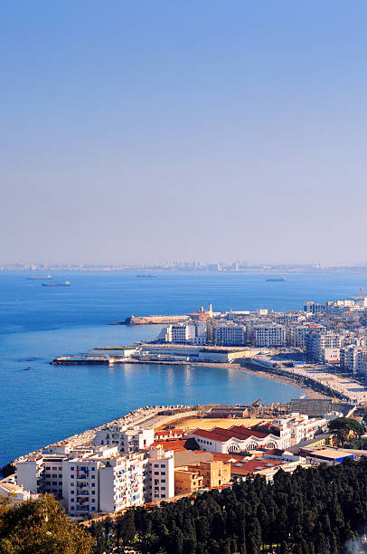 Algiers, Algeria: the city and the Mediterranean Sea Algiers, Algeria: Bab El Oued quarter and St Eugène European cemetery seen from the hill - Algiers Bay, looking towars Kettani point and the lighthouse - Freighter ships in the Mediterranean Sea - Vast area of copy space  algiers stock pictures, royalty-free photos & images