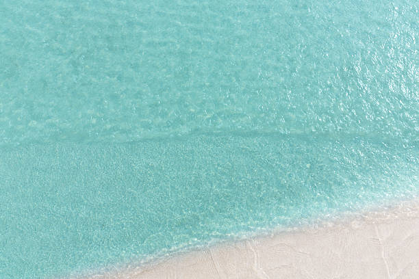 istock Close up blue sea water waves on white sand beach 538337078
