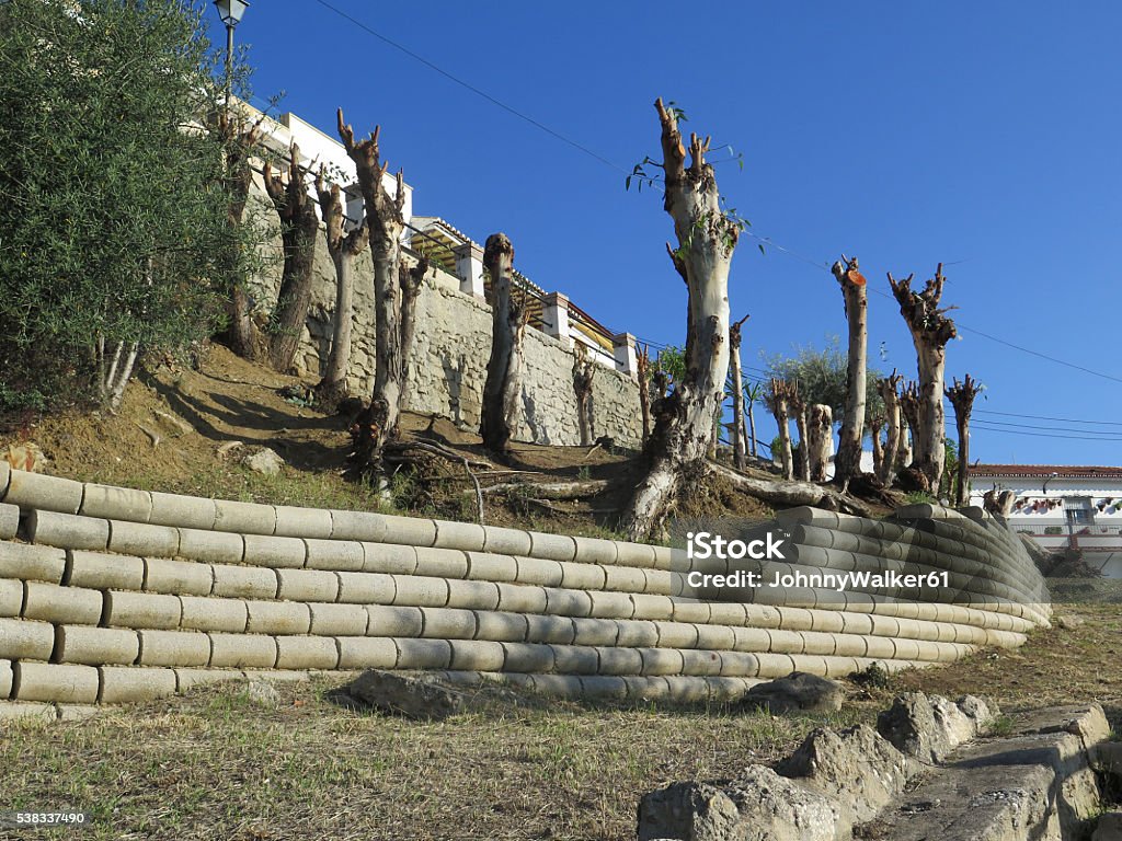 Retaing wall on hillside Retaining wall from rounded concrete blocks in residential street in Alora, Andalucia Andalusia Stock Photo