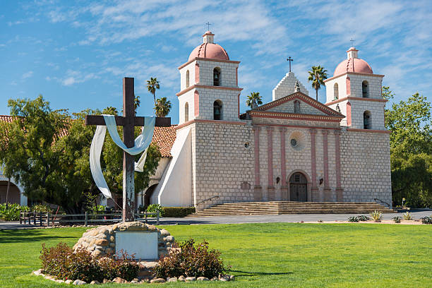 Mission Santa Barbara in Santa Barbara, California with a crosee and a sky blue background