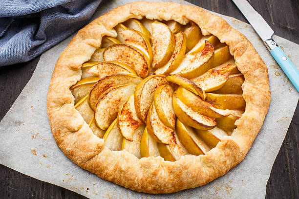 Apple galette Apple galette with cinnamon on a parchment galette stock pictures, royalty-free photos & images