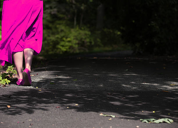 istock Pink Dress Woman walking by herself 538340543