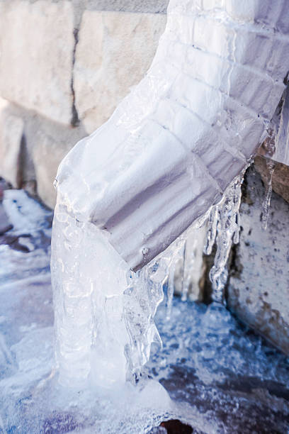 istock Downspout with water turned to ice during snowstorm 538340889