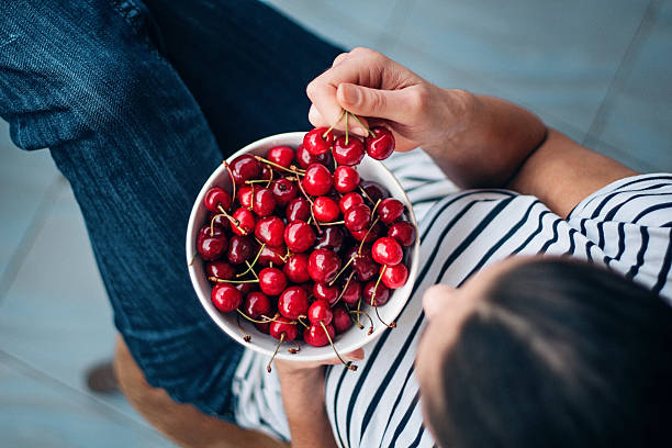 eating cherries young woman with cherries cherry photos stock pictures, royalty-free photos & images