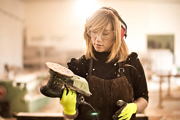 istock Blonde woman with power sander 538342686