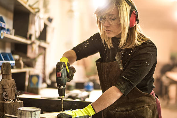 istock Blonde woman working with electric drill 538342888
