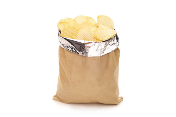 Studio shot of a brown bag full of potato chips isolated on white background
