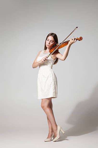 istock Beautiful young woman playing violing 538345396