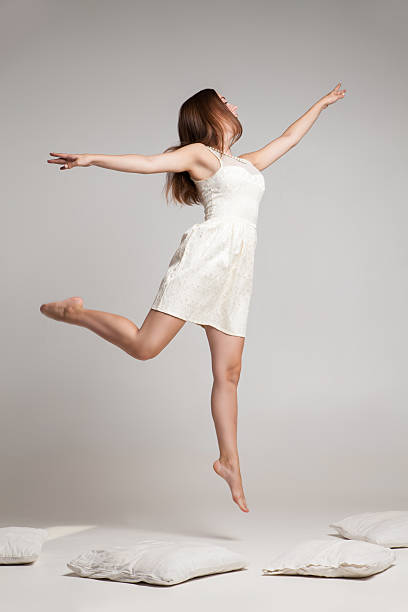 istock Flying brunette in white dress 538346124