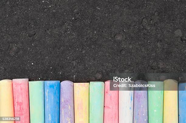 Colorful Pastel Sidewalk Chalk On Dark Asphalt Background Stock Photo - Download Image Now