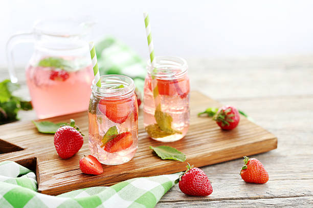 istock Fresh strawberry drink in bottle on wooden table 538346900