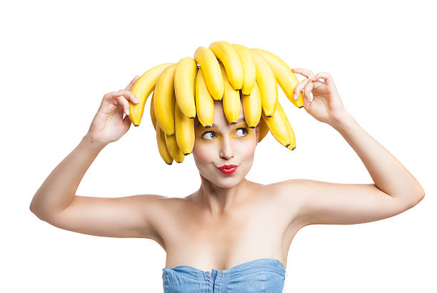 istock Excited model with bananas on head holding one in hand 538346918