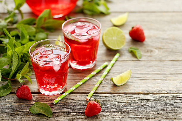istock Fresh strawberry drink in glass with lime on wooden table 538347158