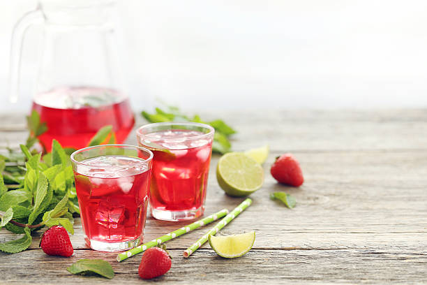 istock Fresh strawberry drink in glass with lime on wooden table 538347212
