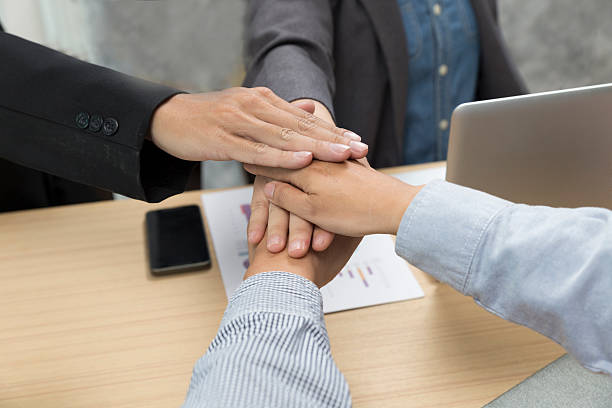 istock united hands of businessmen for use as teamwork concept 538347538