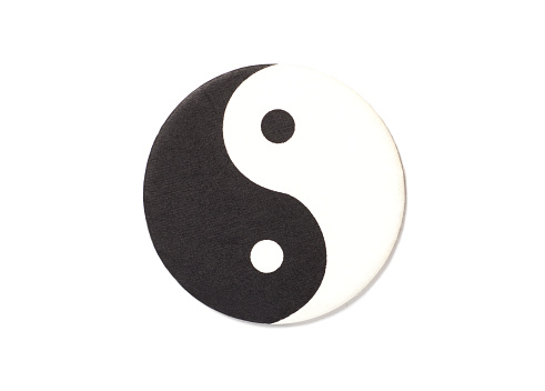 Yin-Yang symbol made of paper top view on white background