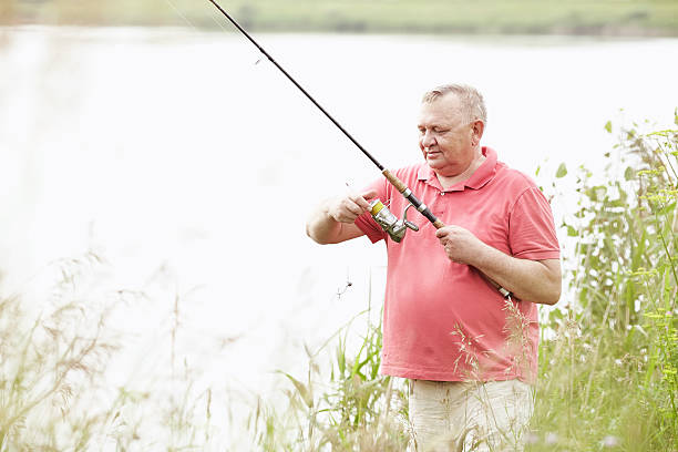 istock Mature angler on lake 538351378