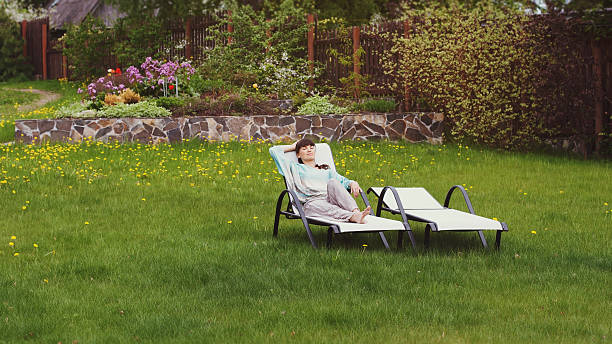istock Girl has rest on a recliner in the yard. 538352330