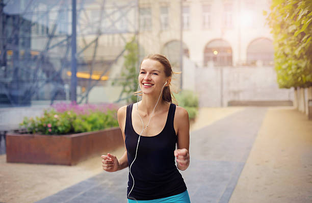 istock smiling woman running with music 538353050