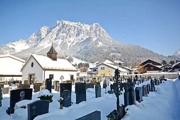 Old cemetery in Ehrwald with Zugspitze summit, Germany's highest mountain