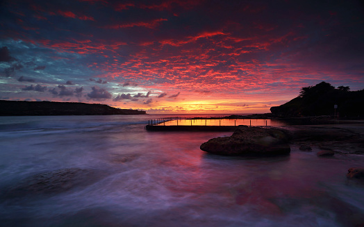 Magnificent sunrise and stunning colour over Malabar ocean rock pool,  in Long Bay, Sydney.