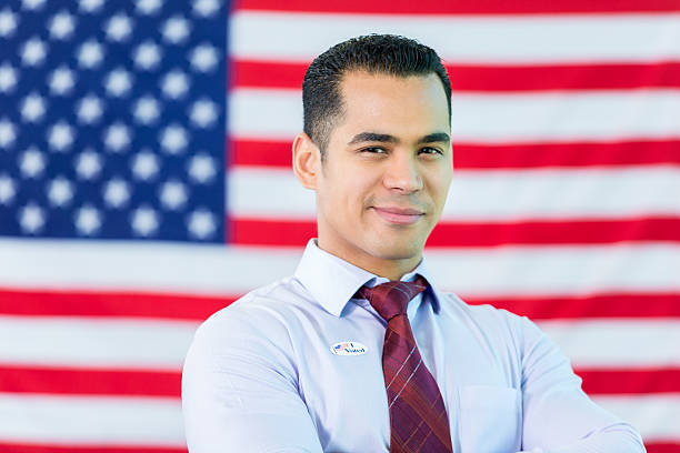 istock Handsome man stands in front of American flag 538355008