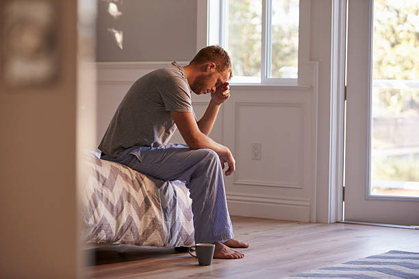 istock Man Wearing Pajamas Sitting On Bed With Head In Hands 538355746