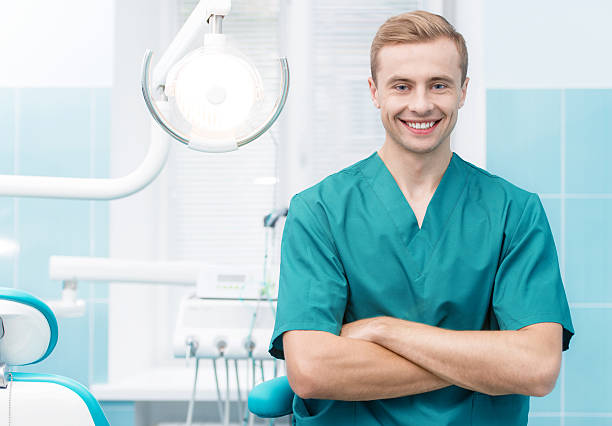 istock Dentist smiling at his dental office 538355859