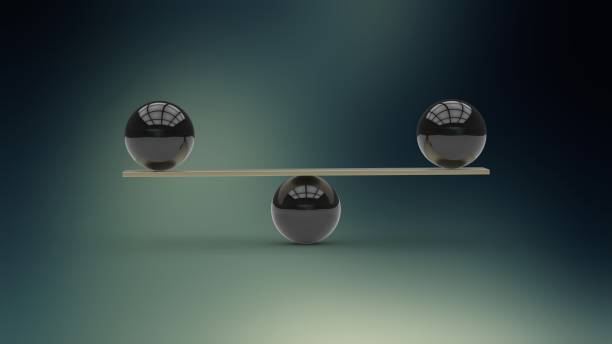 istock Black metallic balls balanced on wooden beam 538356148