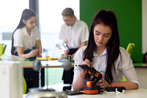 istock Teenage Girl Working on Robotic Arm 538356310