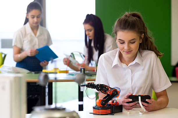 istock Teenage Girl Working on Robotic Arm 538356432