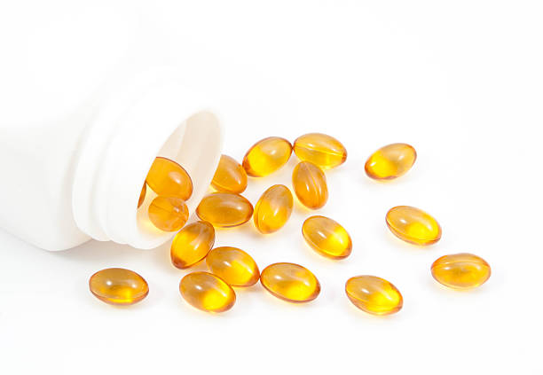 istock Omega 3 fish oil capsules and bottle 538356564