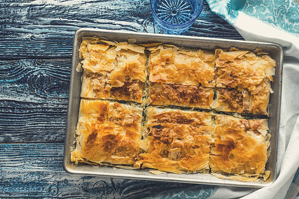 istock Greek pie spanakopita in metal pan  on blue table t 538356962