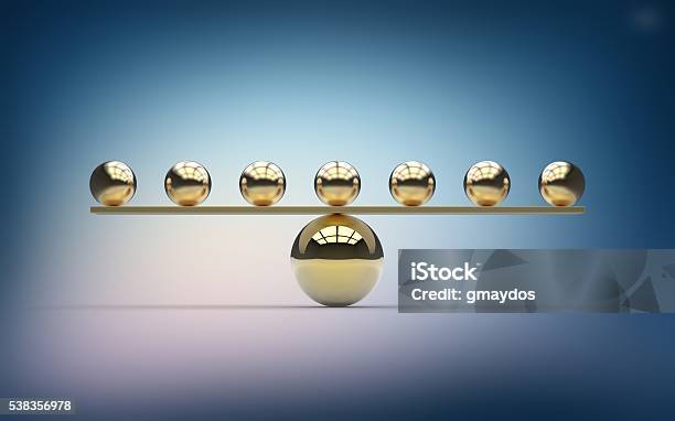 Seven Gold Balls Balancing On One Large Gold Ball Stock Photo - Download Image Now - Stability, Finance, Balance Beam