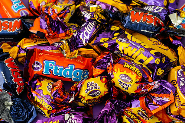 Different Kinds of Cadbury Candy Paphos, Cyprus - November 27, 2015: Cadbury Dairy Milk, Cadbury Dairy Milk Caramel, Wispa, Eclair, Fudge, Creme Egg Twisted and Twirl candy. Full Frame. Studio shot. cadbury plc photos stock pictures, royalty-free photos & images