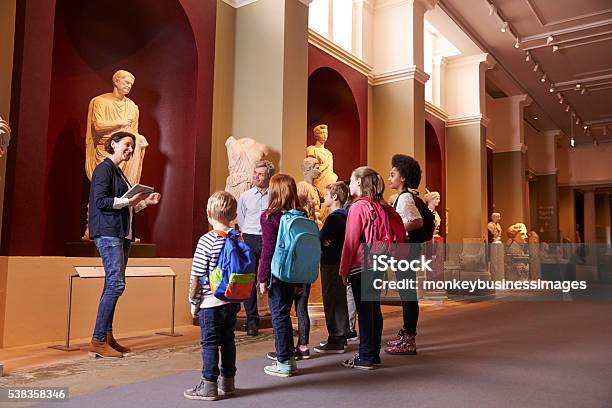 Pupils And Teacher On School Field Trip To Museum Stock Photo - Download Image Now - Museum, Field Trip, Child