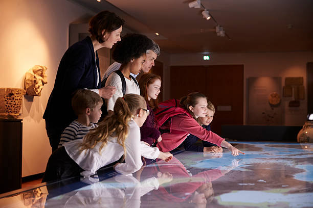 istock Pupils On School Field Trip To Museum Looking At Map 538358378